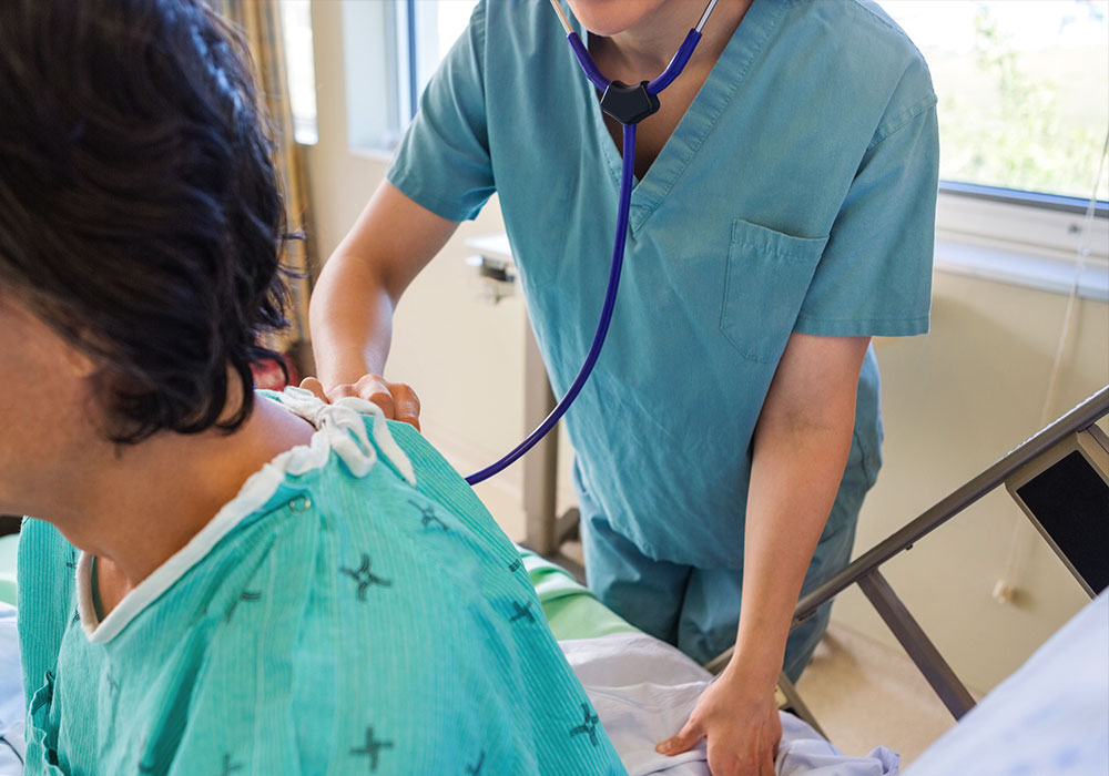 Physician listening to a patient breath using a stethoscope